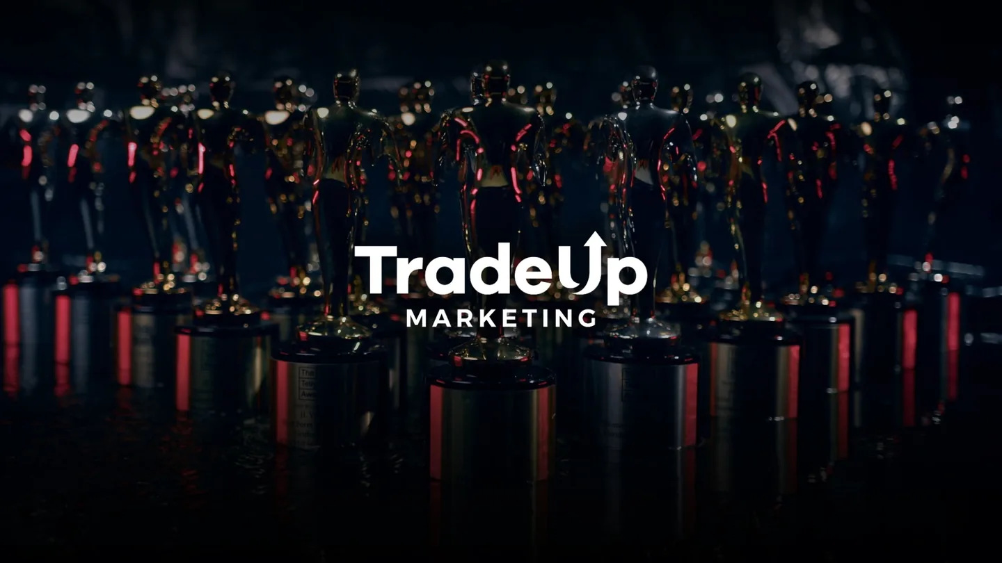 Rows of Telly Award statuettes won by TradeUp Marketing, with the TradeUp Marketing logo